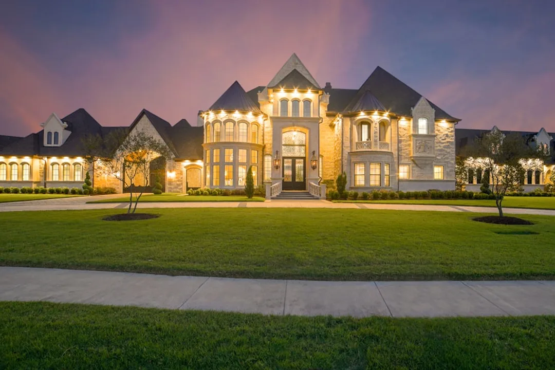 A modern house at dusk with warm interior lighting